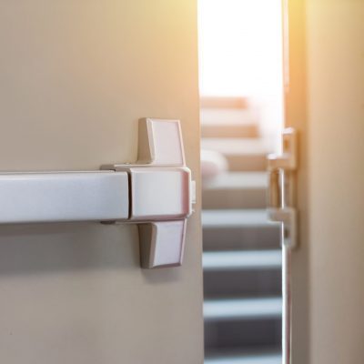 Emergency fire exit door. Closed up latch and rusty door handle